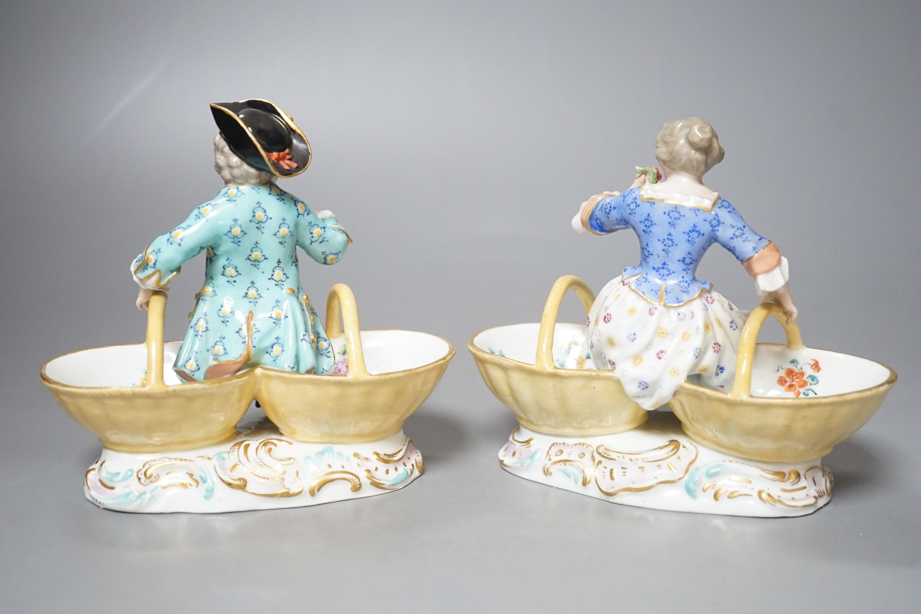 A pair of Meissen porcelain figural sweetmeat baskets, one incised number 3024, both initialled L.J.